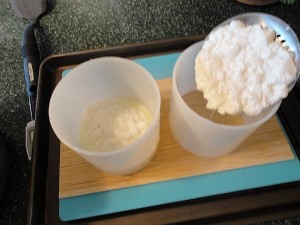 Ladling the curds into the molds to drain and consolidate.